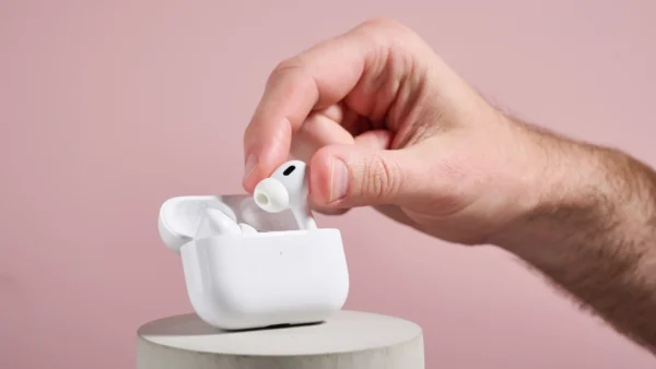 a_man_holding_an_airpods_pro2_in_his_hand