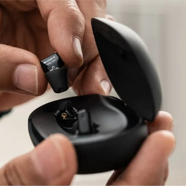 a_man_is_holding_a_sony_cre_c10_with_charger_case_open