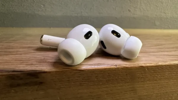 a_pair_of_white_airpods_pro2_sitting_on_top_of_a_wooden_table